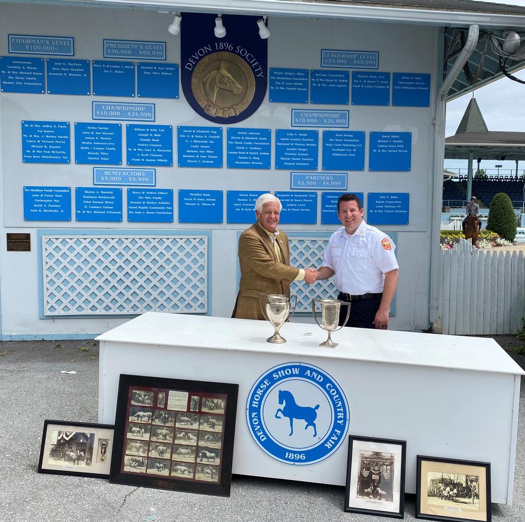 Devon Horse Show CEO & Chairman Wayne W. Grafton greets Phoenixville Fire Department Chief Eamon C. Brazunas as historic Phoenixville fire horse memorabilia is shared for display during the upcoming 2022 show.